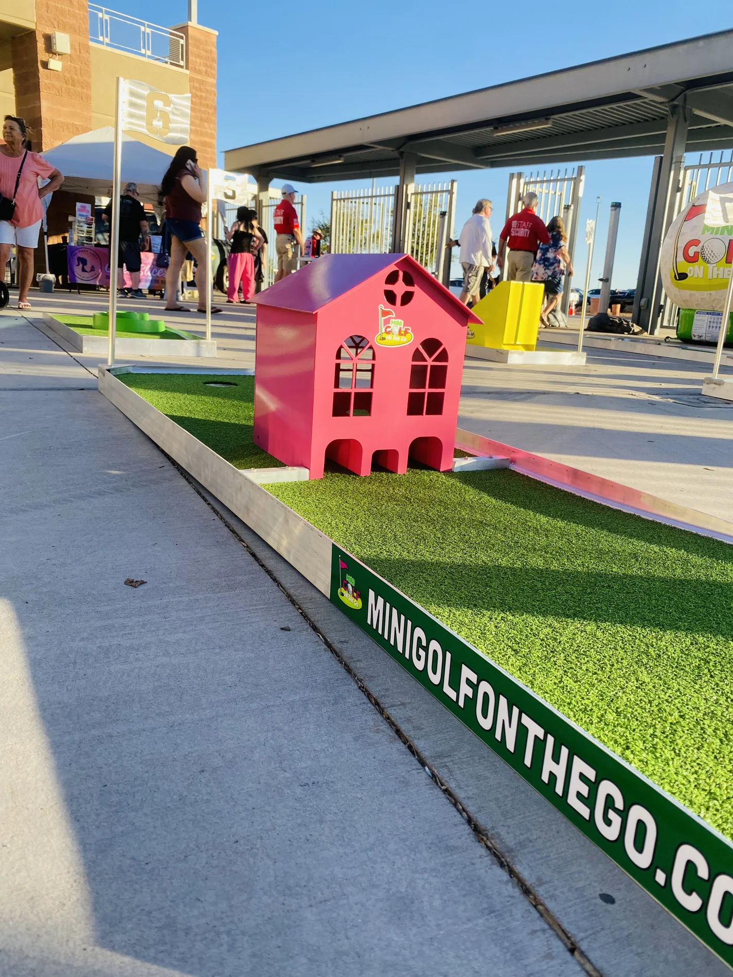 A colourful pink-house obstacle on the portable Mini Golf on the Go course